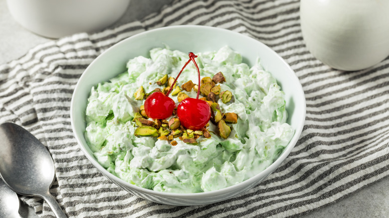Watergate salad with cherries on grey and white fabric