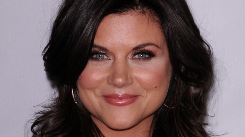 Tiffani Thiessen smiling on red carpet