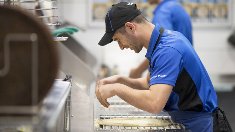 An employee at a Domino's