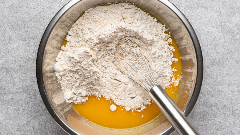 Mixing bowl with ingredients and whisk
