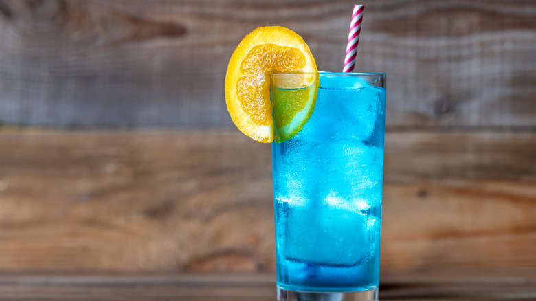 blue drink with straw and lemon slice