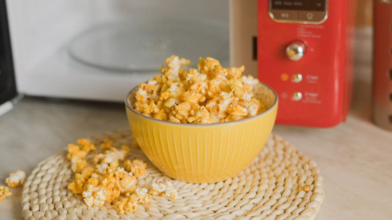 Cheesy popcorn and open microwave
