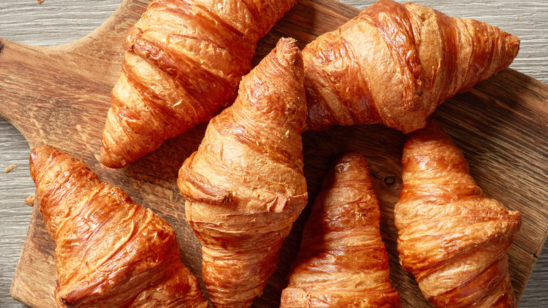 Croissant pastries on wooden plate