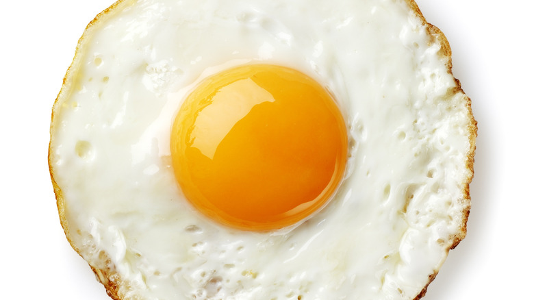 Perfectly circular fried egg on white background