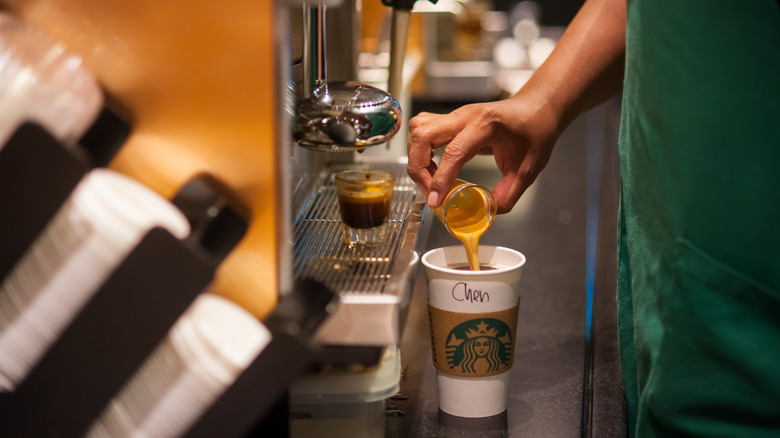 A Starbucks barista preparing a drink