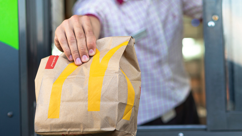 McDonald's drive-thru employee with bag