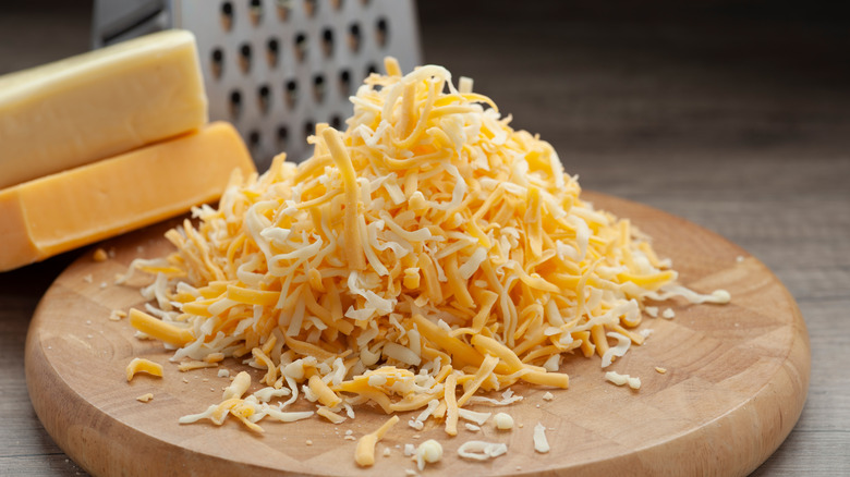 Shredded mozzarella and cheddar with cheese grater