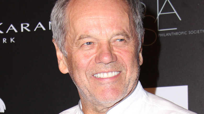 Wolfgang Puck smiling in chef's jacket