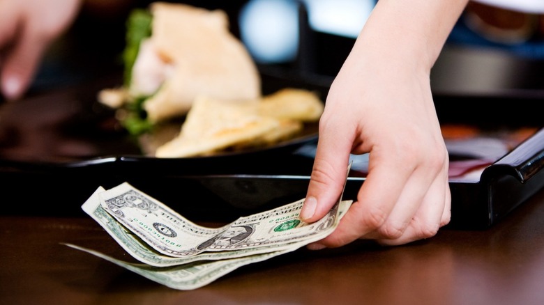 restaurant server collecting cash tip