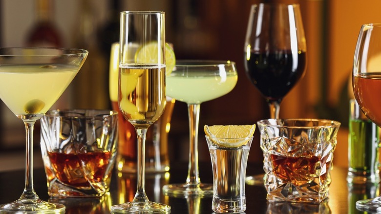 Different alcoholic drinks in various types of glasses.