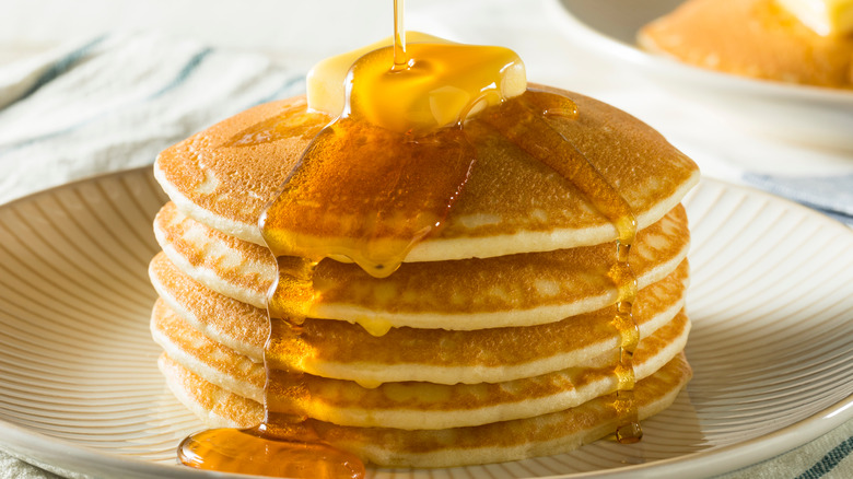 Stack of pancakes with butter and syrup