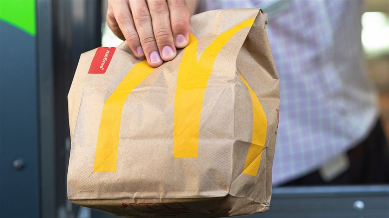 McDonald's food bag in someone's hand