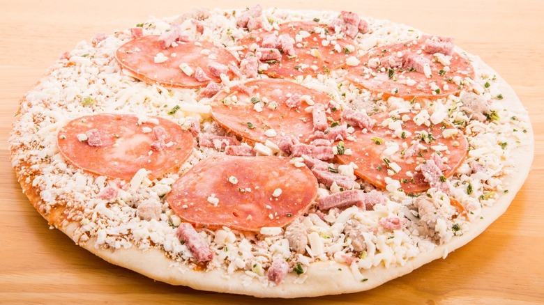 Frozen pizza with meat toppings