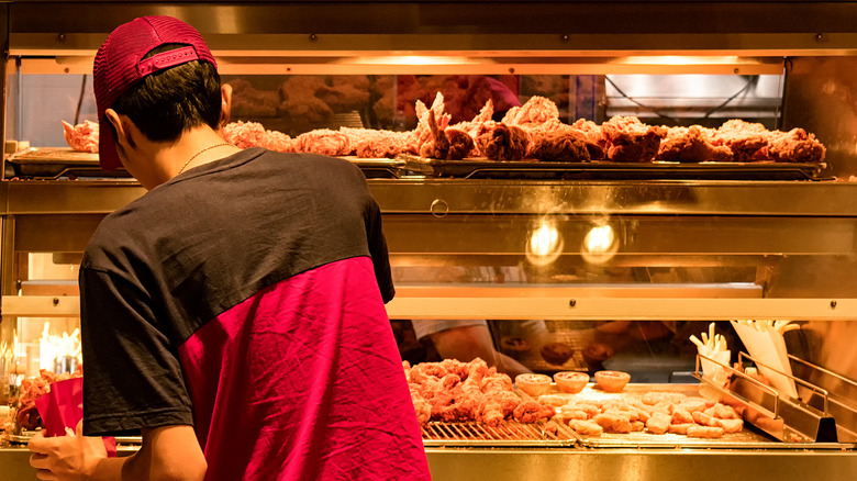 A fast-food employee working in the kitchen