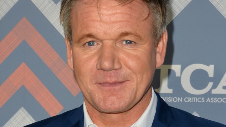 Gordon Ramsay smiles with white shirt and dark blazer