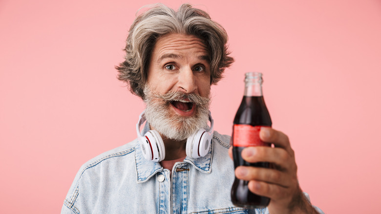 Happy man holding soda