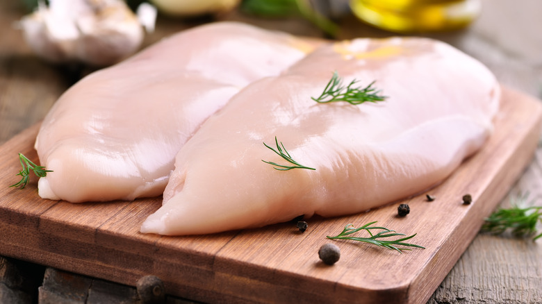 raw chicken breasts with herbs