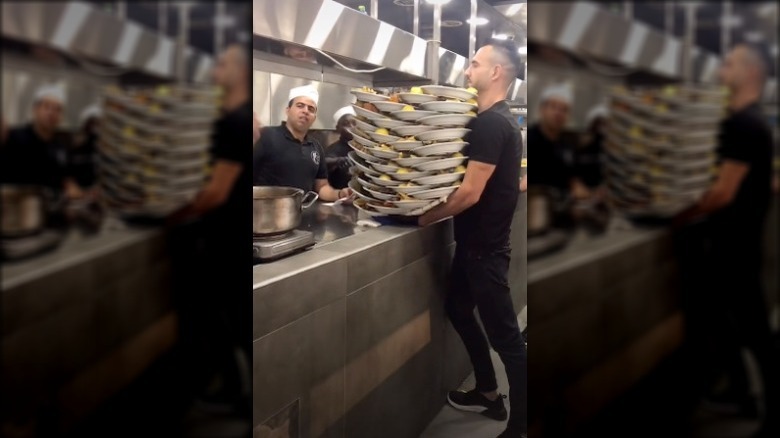 Waiter carrying 130 pounds of food 