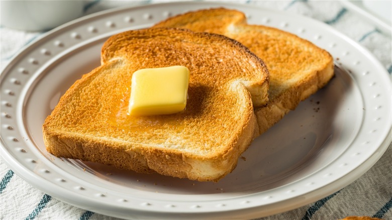 two slices of buttered toast on a plate