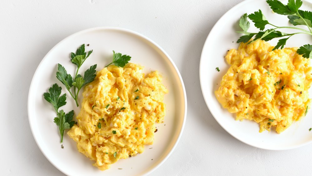 two plates of scrambled eggs