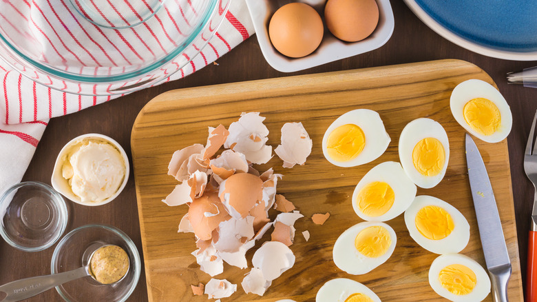 Person prepping hard boiled eggs for deviled eggs