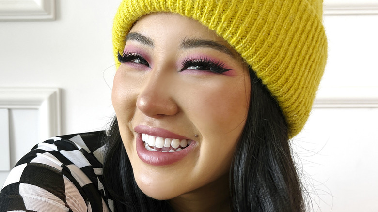 Ashley Yi smiling in yellow beanie