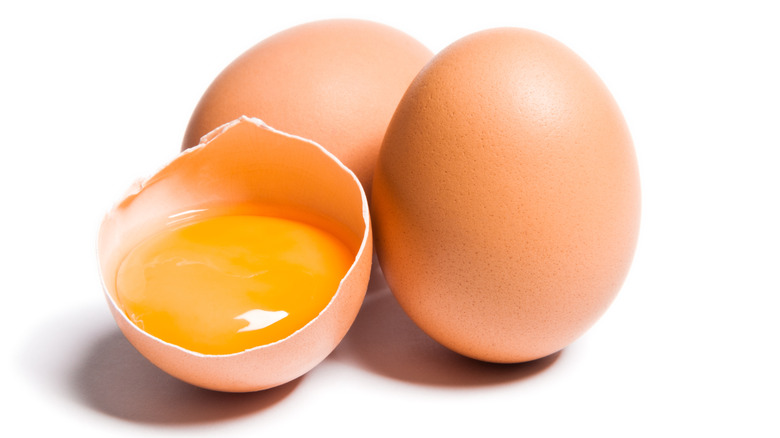 three brown eggs, one craked