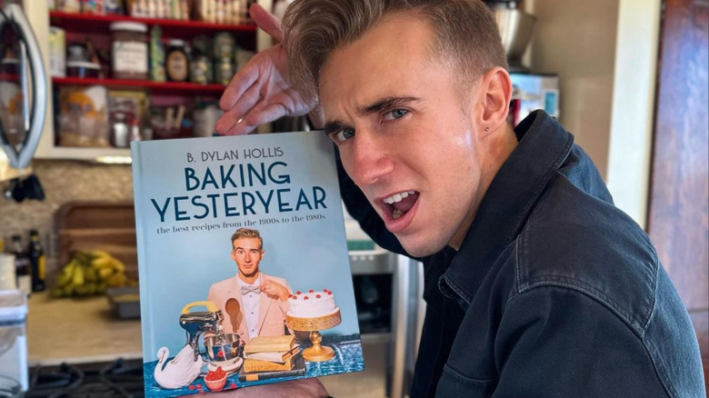 B. Dylan Hollis holding his cookbook