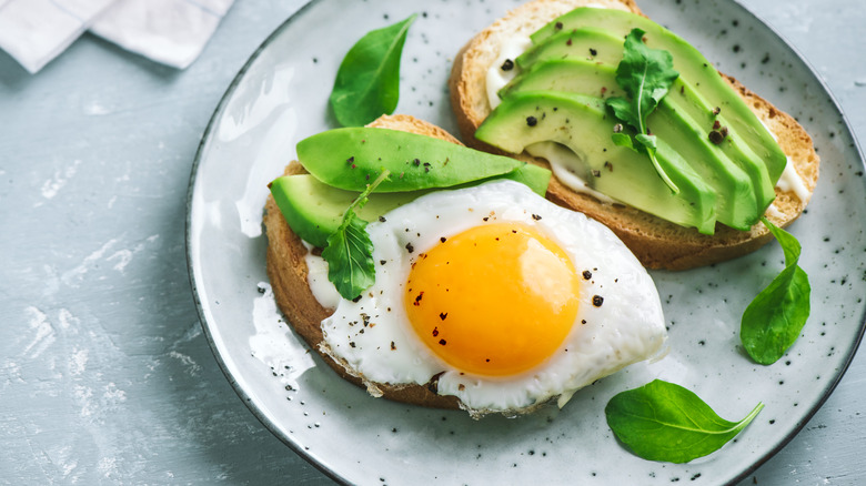 Two slices of avocado toast on a plate