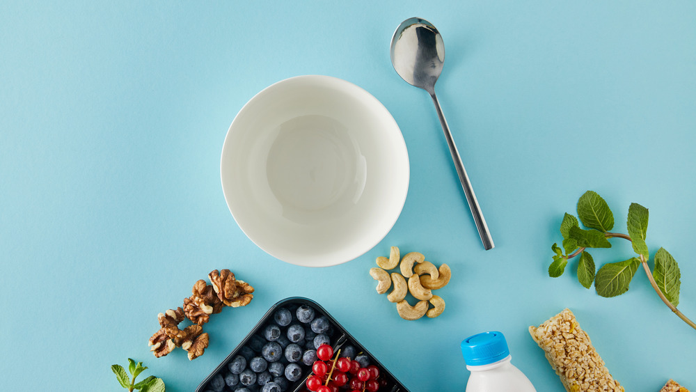 Empty cereal bowl surrounded by fruit