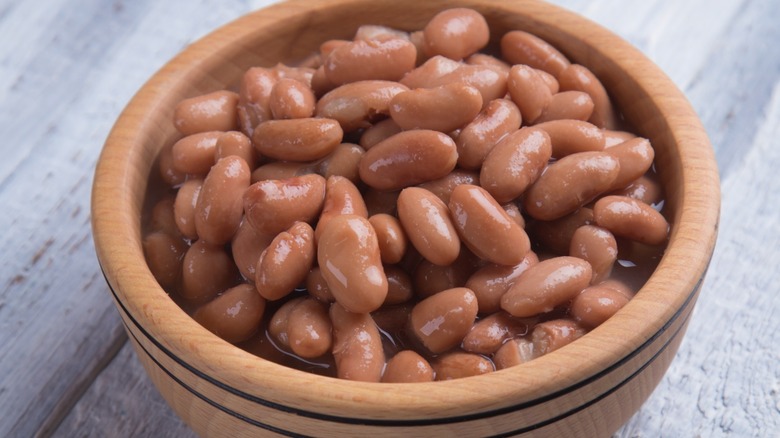 A wooden bowl of pinto beans 