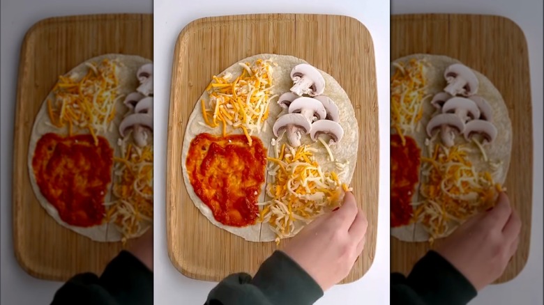 Hand preparing pizza quesadilla