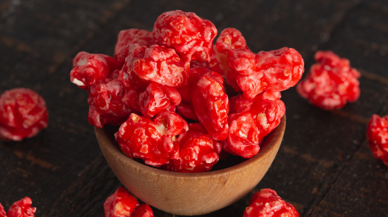 Red popcorn in a wooden bowl