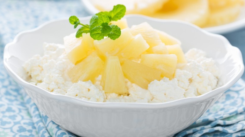 A bowl of cottage cheese topped with diced pineapple