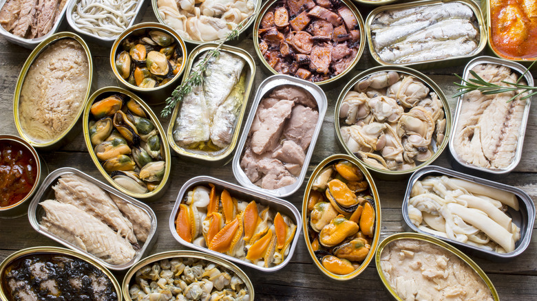 variety of open tins of canned fish