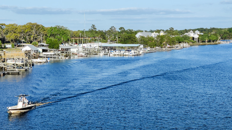 Boat passing docks along river