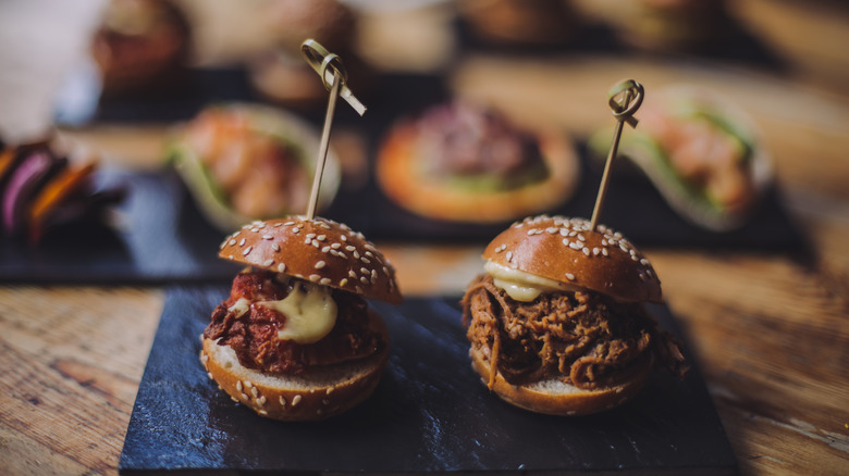 Sandwich canapes on napkin on wood table