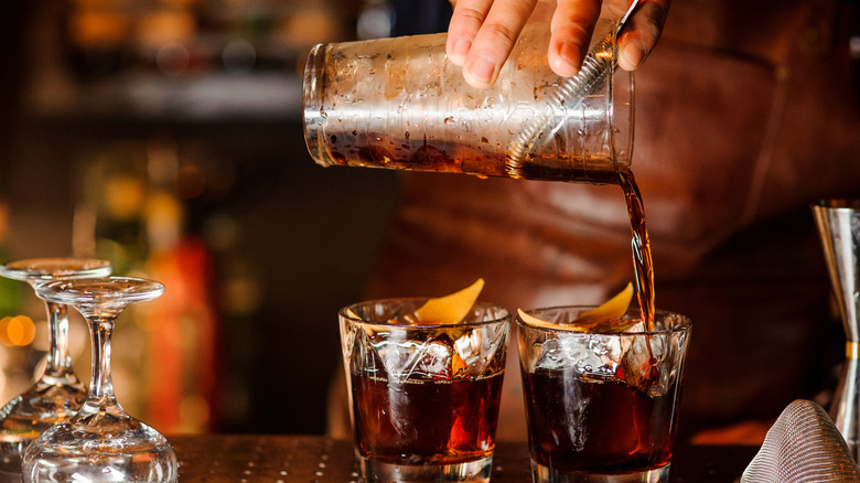 Pouring liquor into glasses