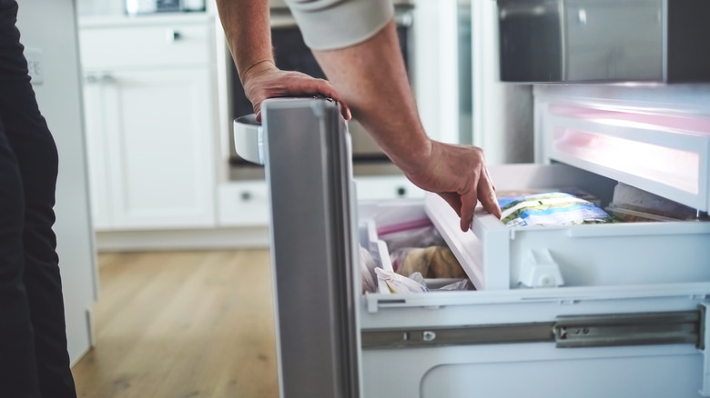 Person opening freezer