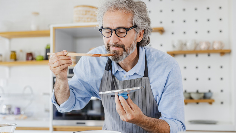 Man tasting cooking from pot