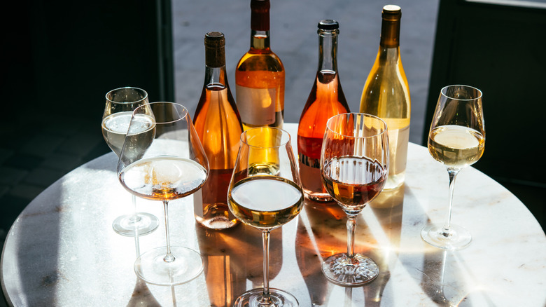 Various bottles and glasses on wine on table