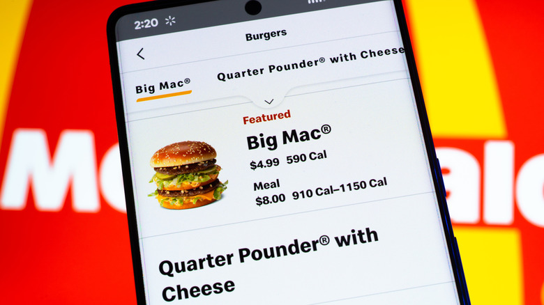 A smartphone screen with app ordering McDonald's Big Mac and quarter pounder with cheese