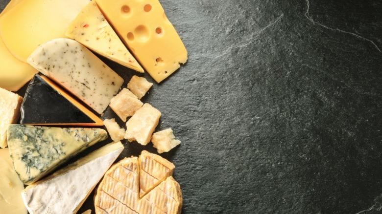 Various cheeses on a black background