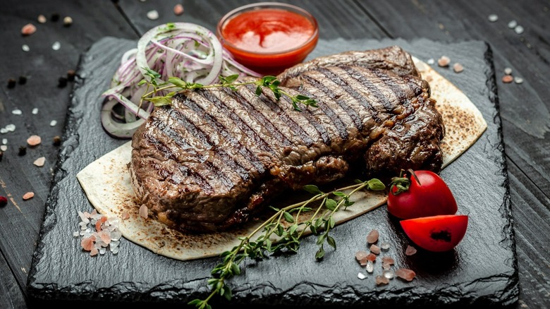 Cooked steak on platter with veggies