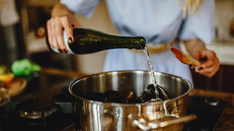 woman pouring wine into pan