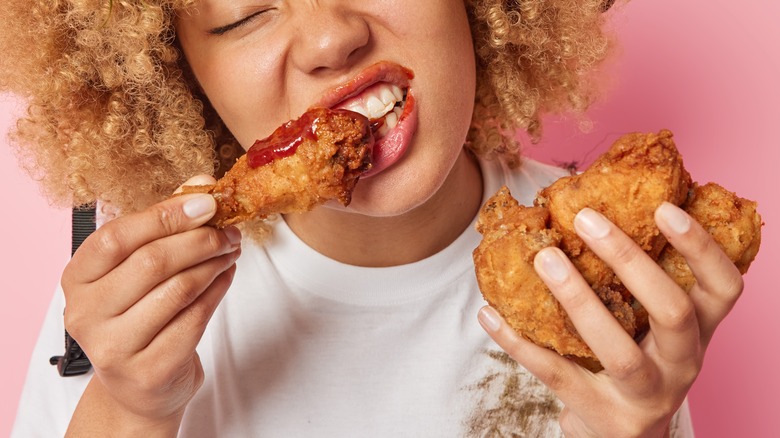 woman eating fried chicken