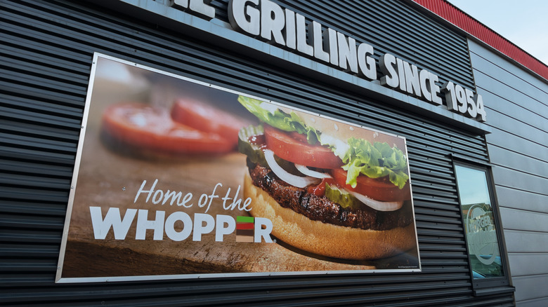Burger King exterior with "Home of the Whopper" sign.