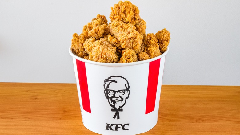 An overflowing bucket of KFC chicken.