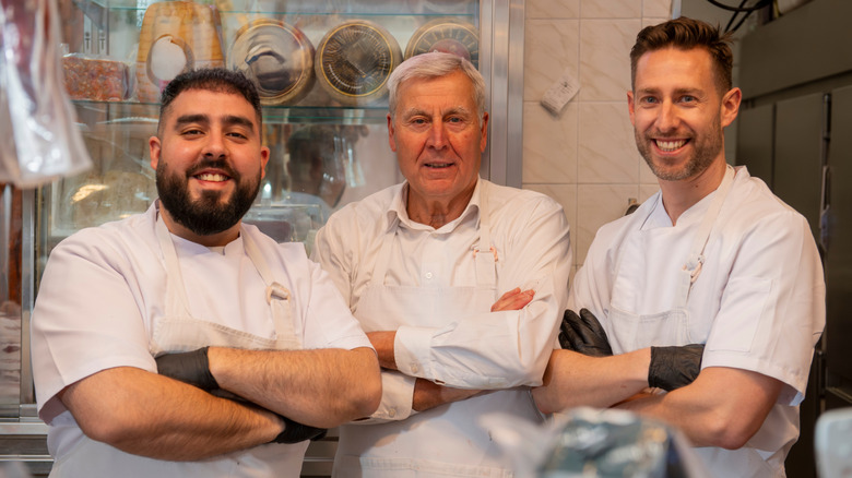 Three butchers with crossed arms