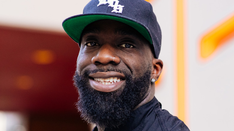 Chef and Food Network competitor Tobias Dorzon wearing a baseball cap and smiling at the camera